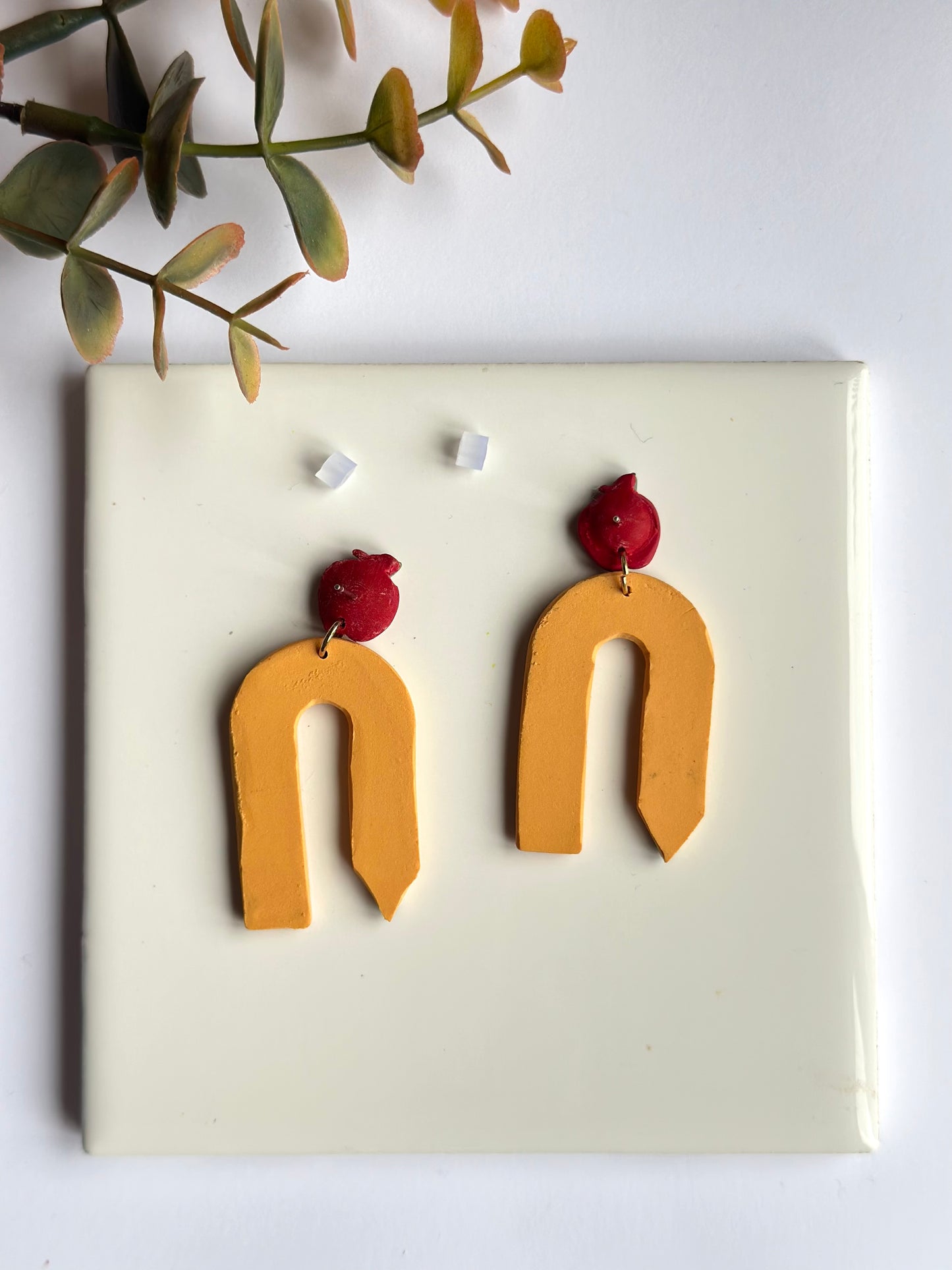 arched pencil dangles